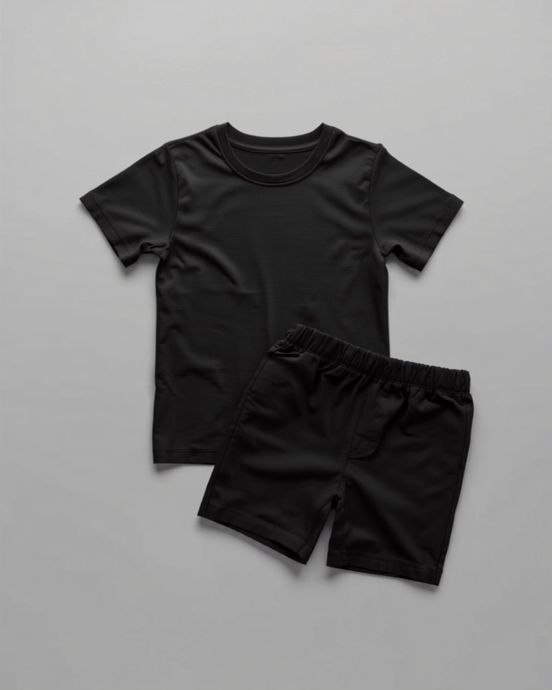 Kids plain black cotton co-ord set - half sleeve t-shirt and shorts flat lay